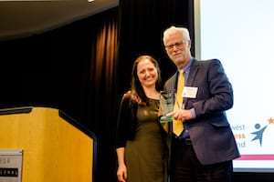 Picture of Dr. Richard Ladner presenting award to Dr. Anat Caspi