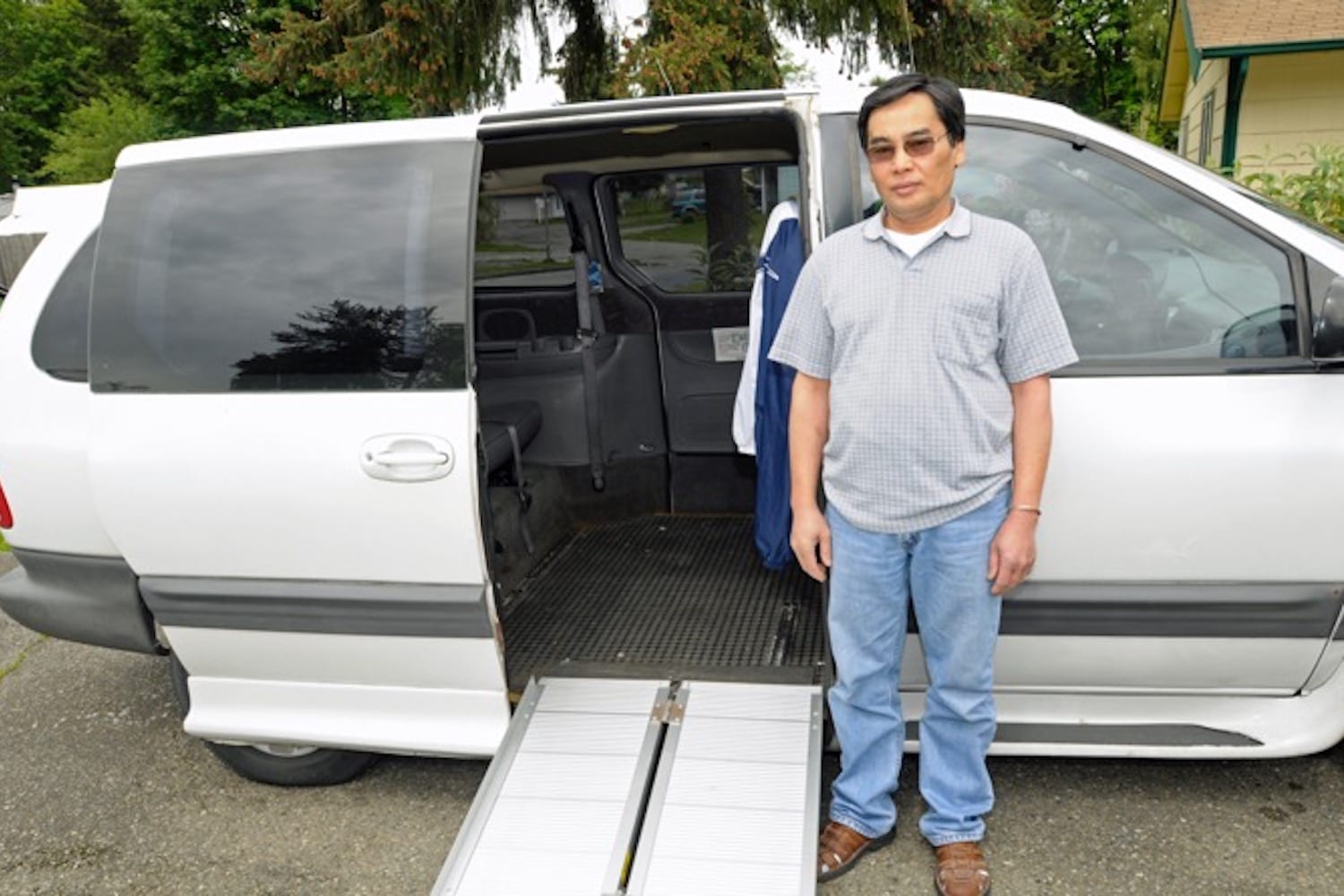 Photo of a client next to a modified van he financed through NWAF