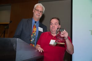 Dr. Richard Ladner presenting award to Kelly Ford with Microsoft's Disability Answer Desk