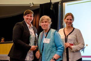Debbie Cook presenting award to Microsoft representatives 