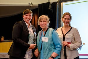 Debbie Cook presenting award to Microsoft representatives 