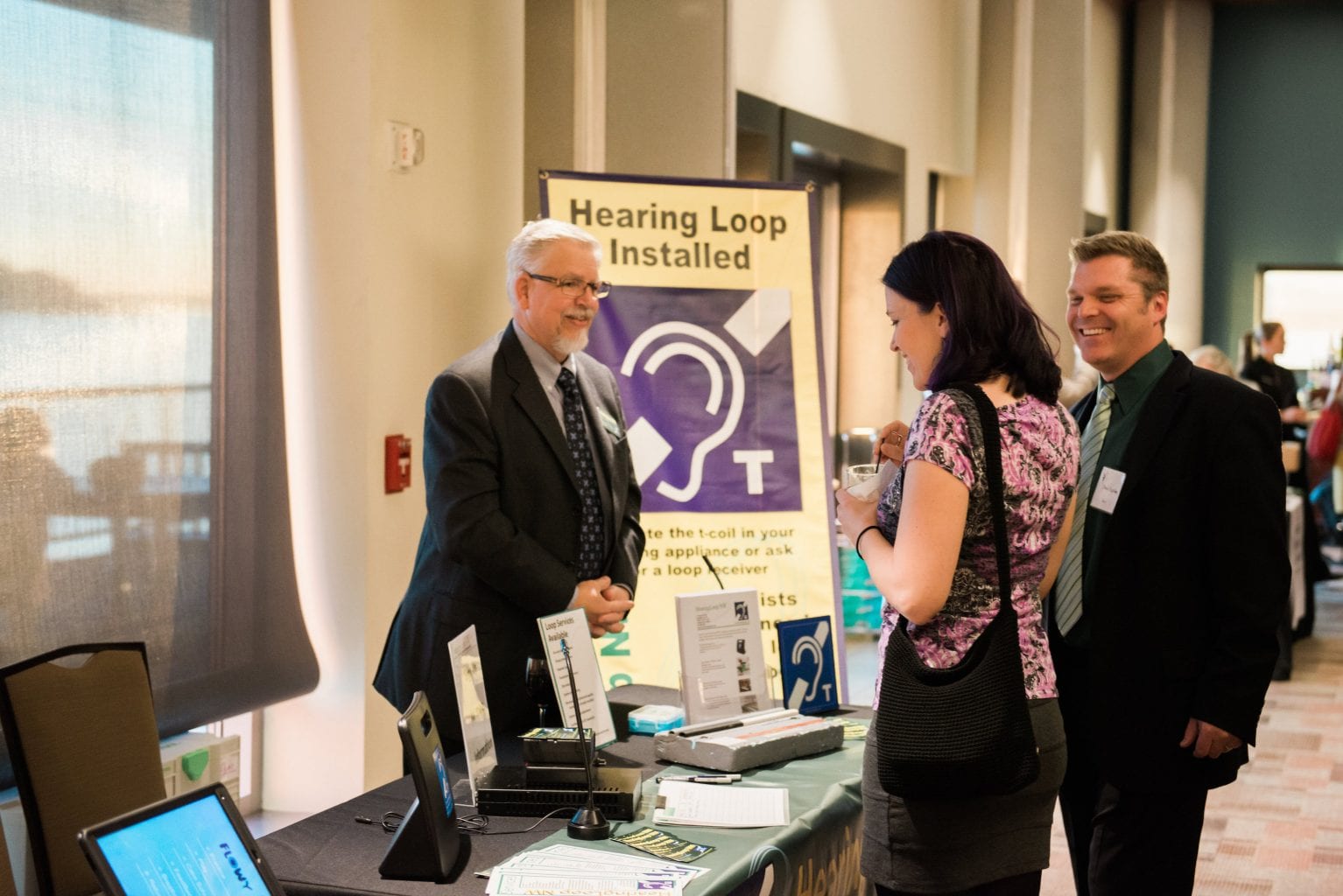 Spencer Norby Tabling promoting installations of hearing loops. 
