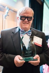Picture of Tim Carter holding his award