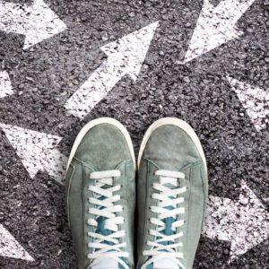 Shoes surrounded by arrows pointing in different directions
