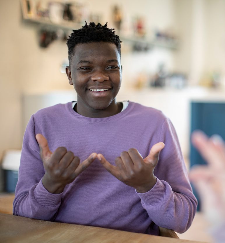 Teenage boy having a conversation using sign language