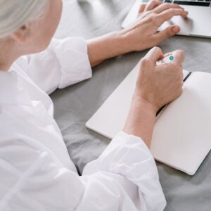 Woman at computer with notebook