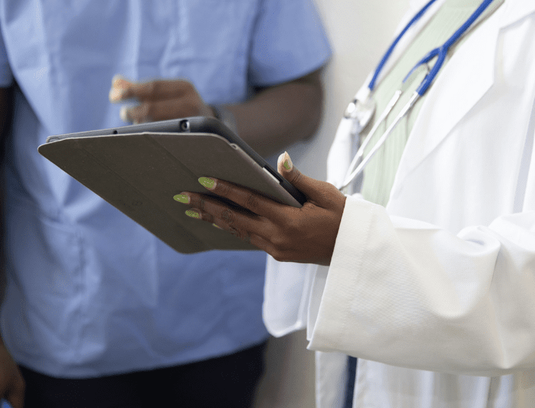 doctor's hands holding a tablet