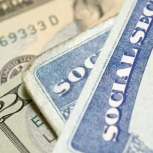 Social Security cards on top of a couple $20 bills