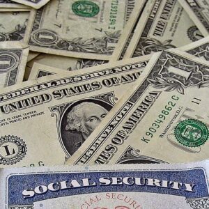 Social Security card on top of one dollar bills